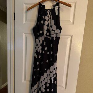 Sleeveless cocktail dress with hankerchief hem.